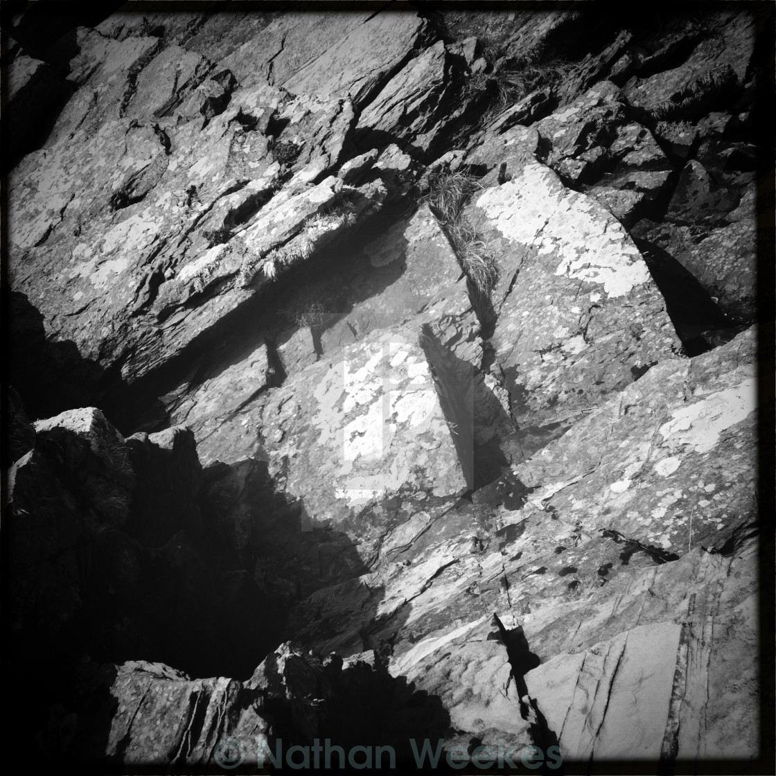 "A black and white rock face" stock image