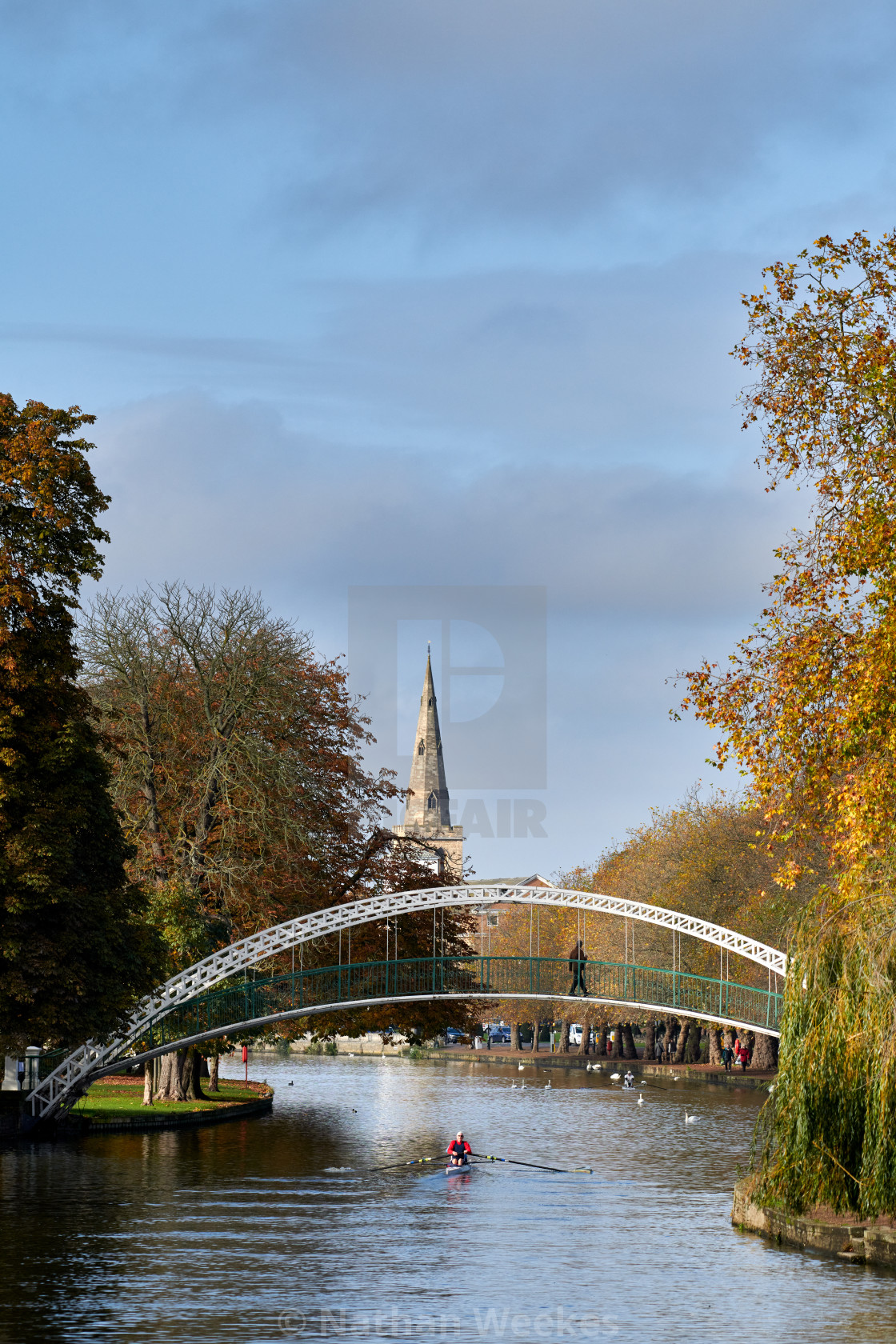 "A rower passes under Bedford Suspension Bridge on an autumn morn" stock image