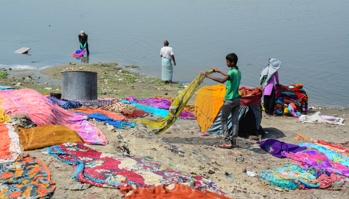 Washing And Drying Clothes On The Sandy Banks License Download