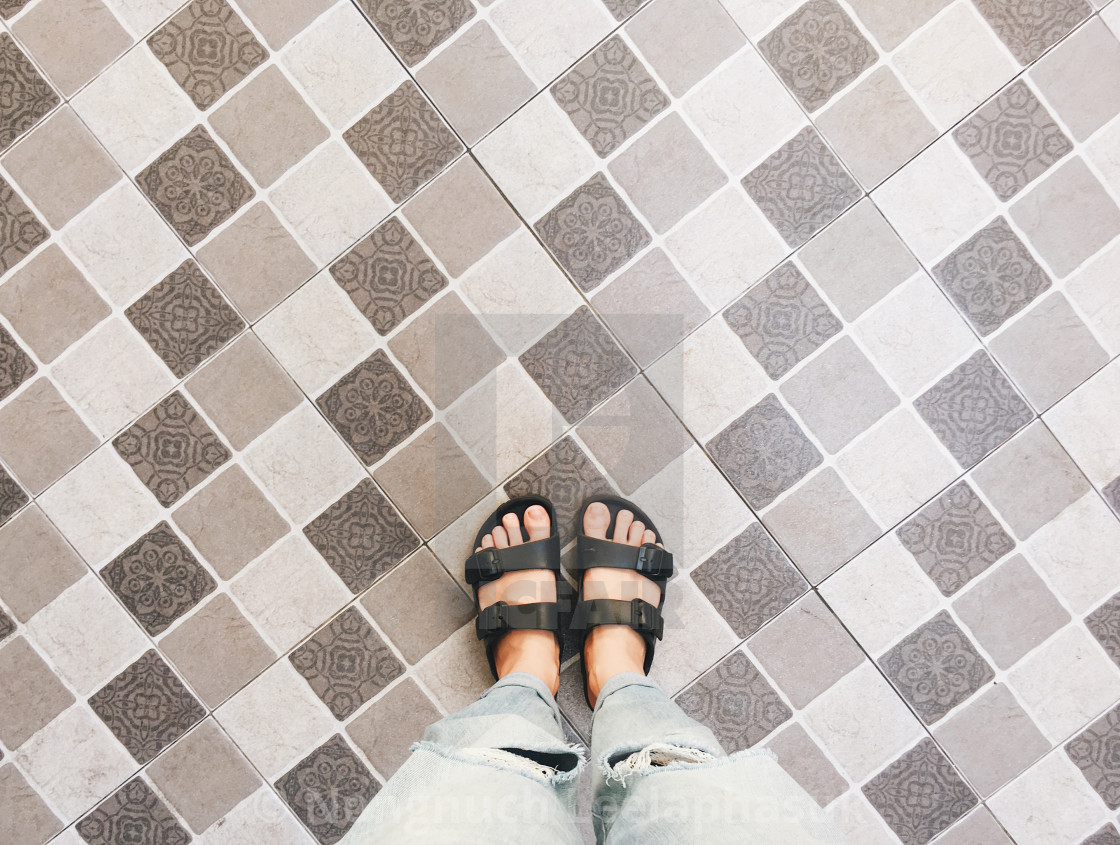 Top view of selfie feet in sandals shoes standing on floor - License,  download or print for £ | Photos | Picfair