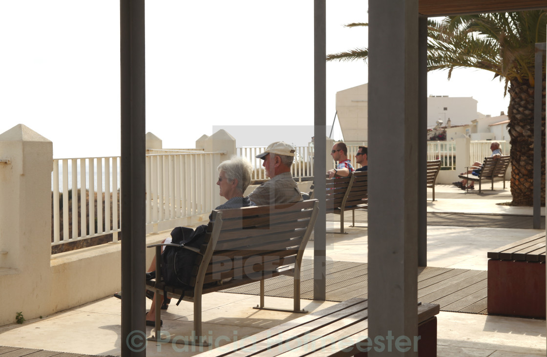 "People relaxing on a bench and enjoying the view" by Patricia Hofmeester - £12.40 "People relaxing on a bench and enjoying the view" stock image