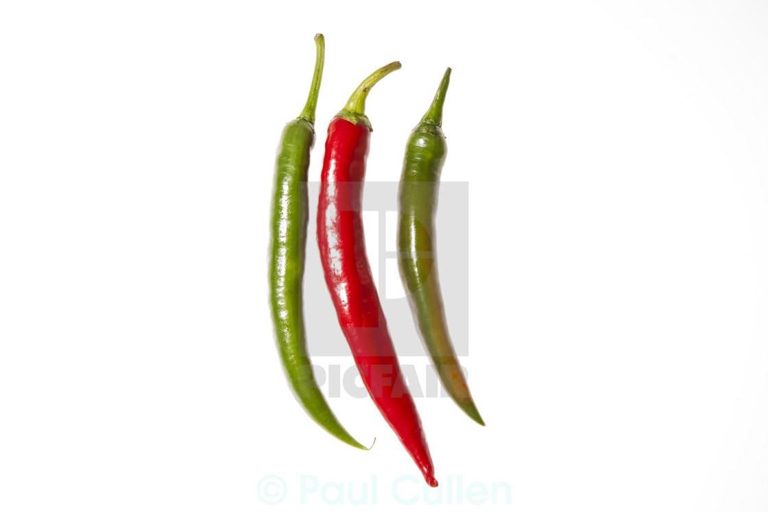 "Three peppers arranged vertically" stock image