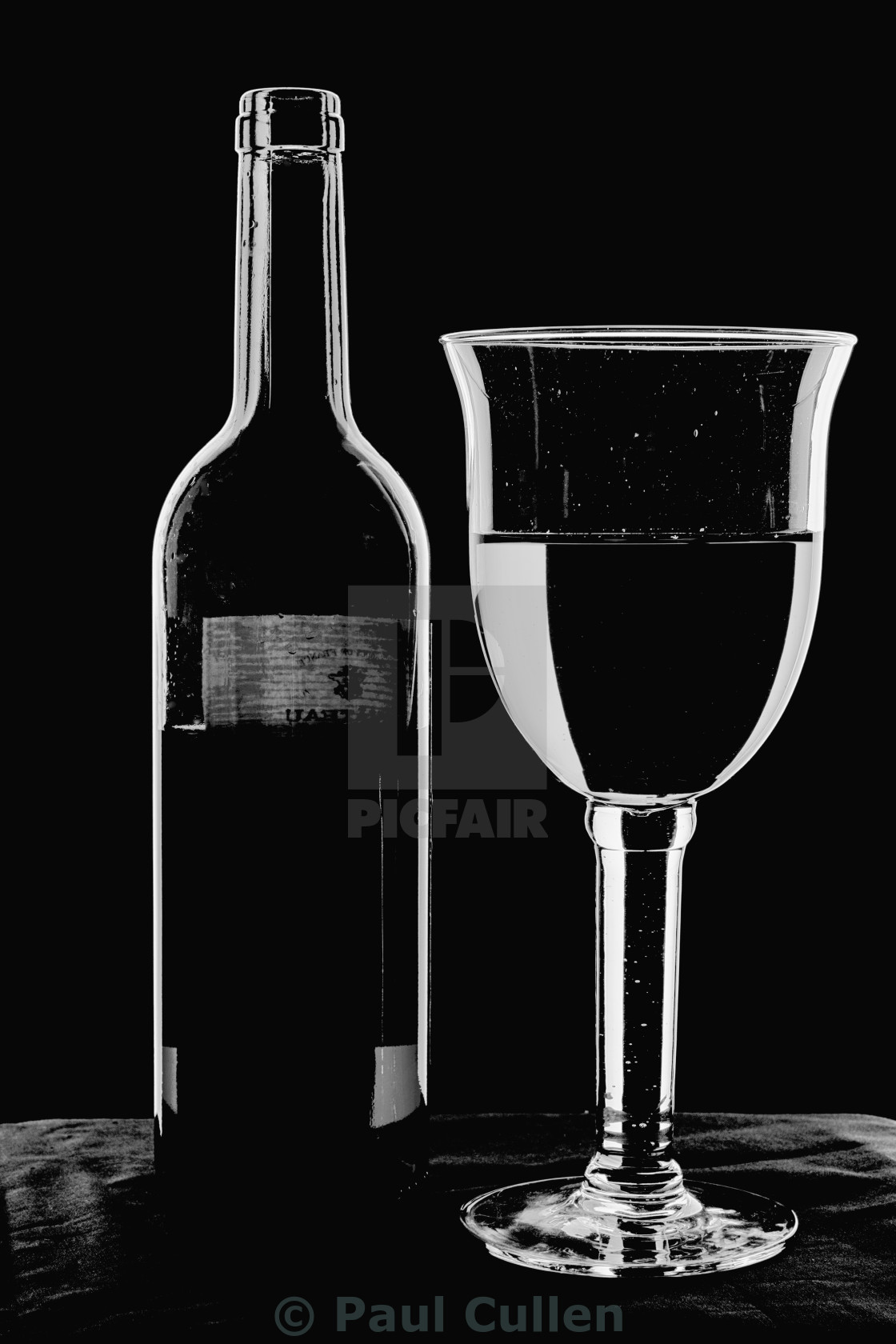 "Bottle and Glass - high key monochrome." stock image