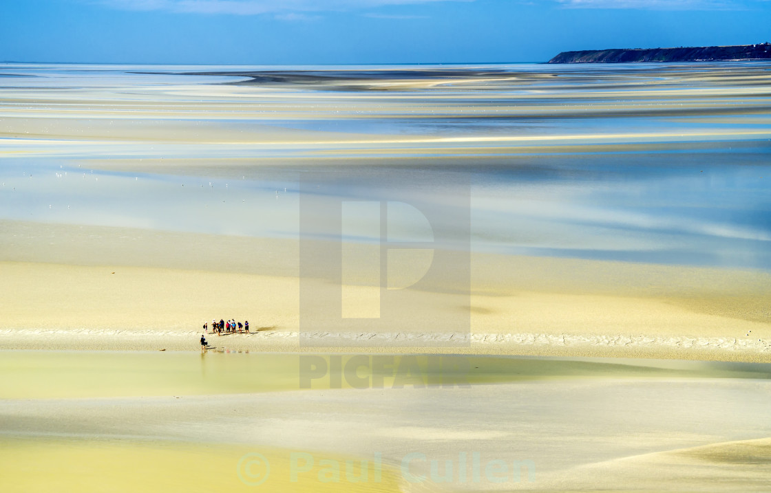 "The Bay of the Mont Saint-Michel - walkers on the sand." stock image