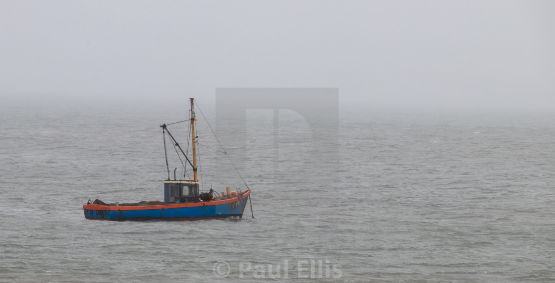 "Fishing boat on a misty day" stock image