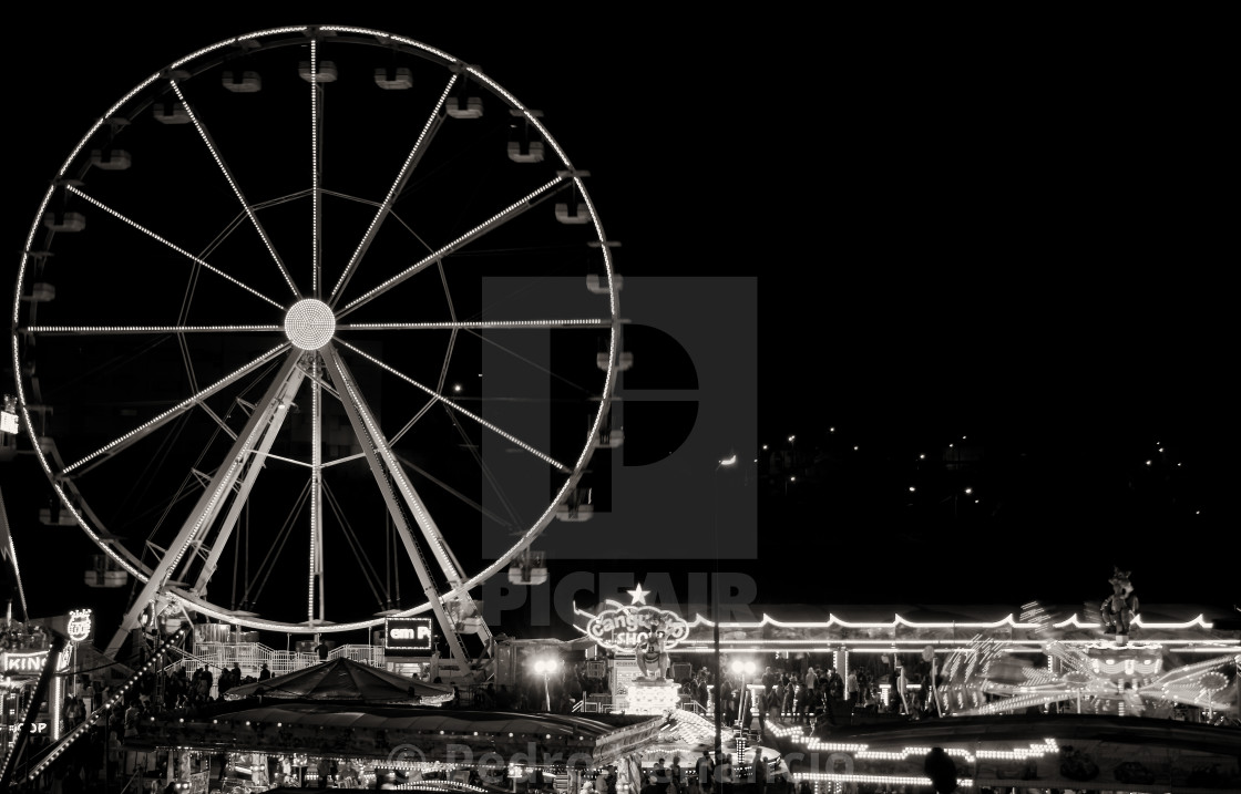 "Night photography of the fair and its diversions, Ferris wheel and other amusements, long exposure" stock image