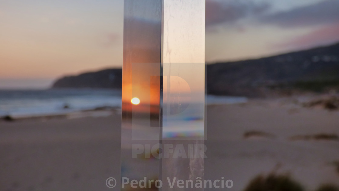 "Sun reflex on crystal prism on the beach" stock image