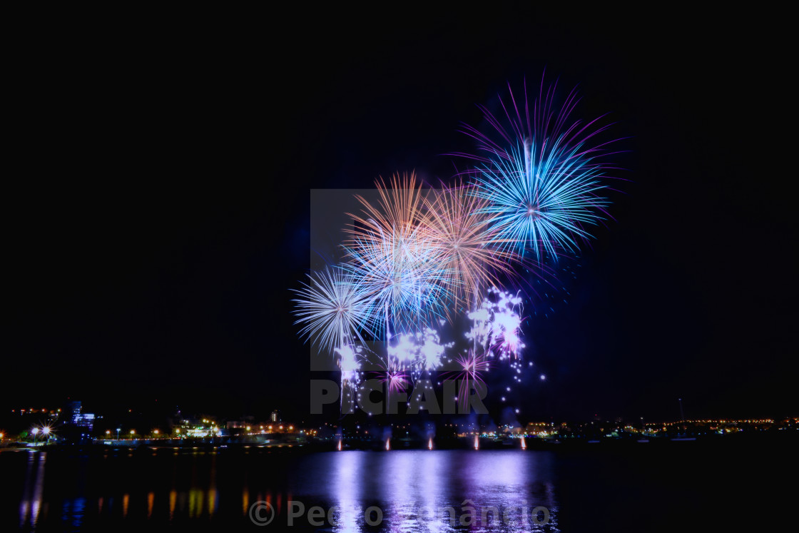 "Fireworks in the water at night" stock image