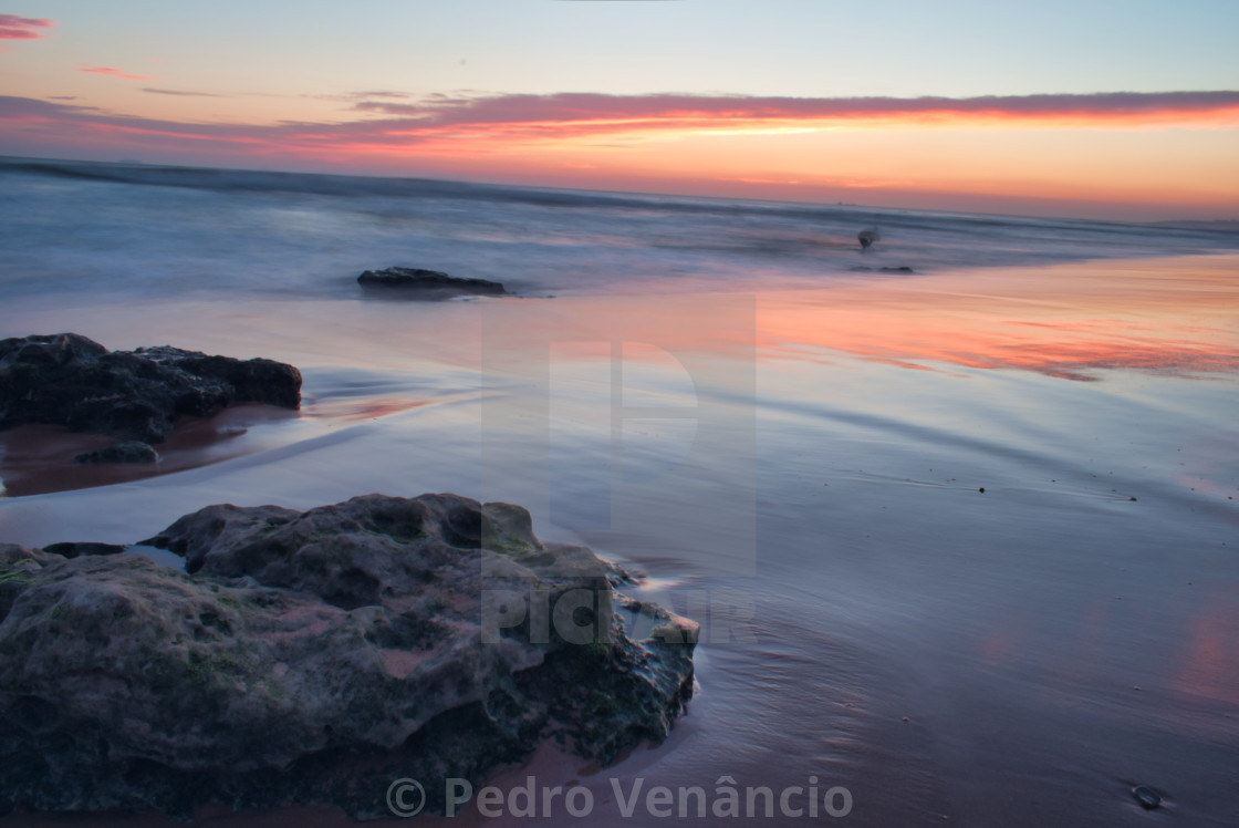 "Beach water at sunset long exposure" stock image