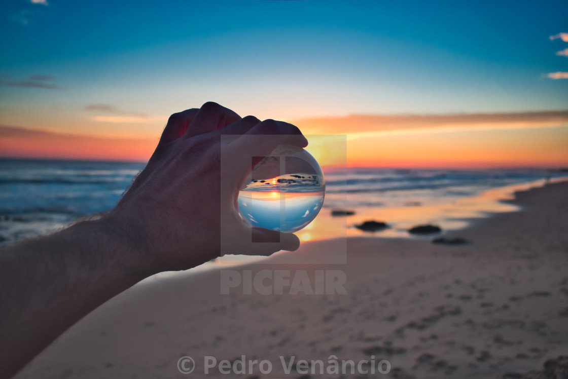 "Cristal Ball Holding on Beach Sunset" stock image