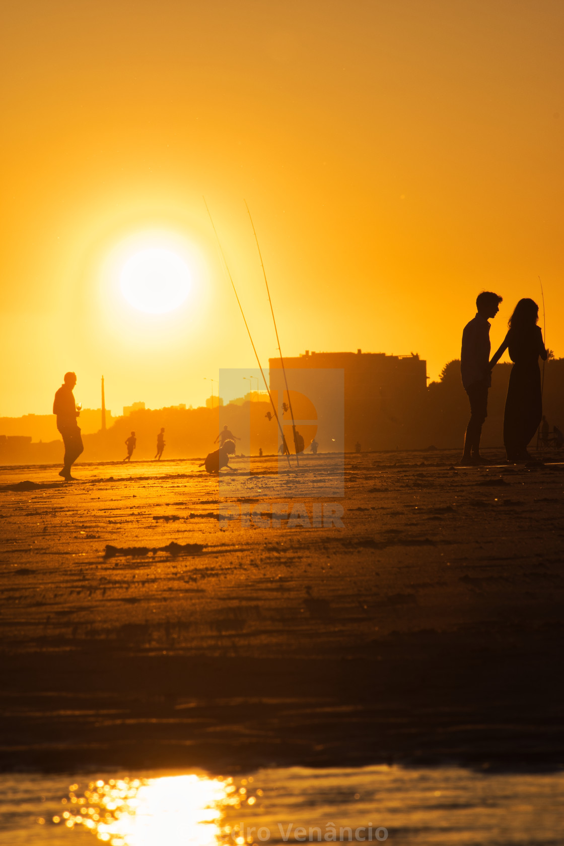 "Portugal Carcavelos Beach - People silhouettes at sunset on the beach in the golden hour" stock image