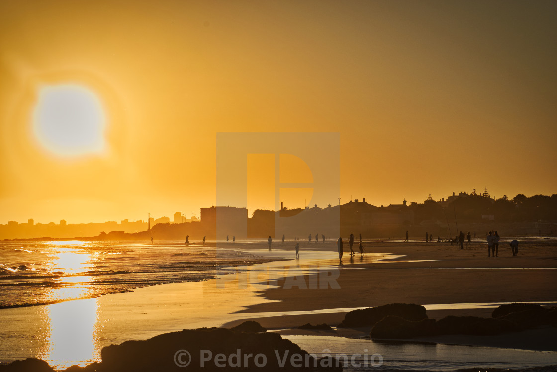 "Portugal Carcavelos Beach - People silhouettes at sunset on the beach in the golden hour" stock image