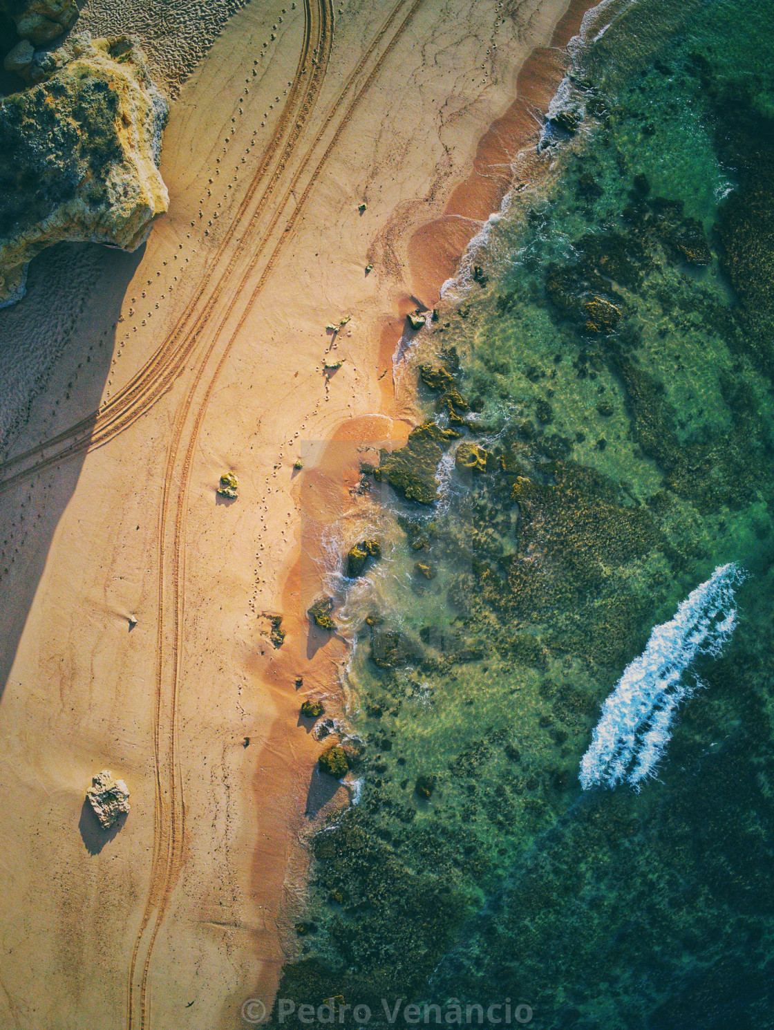 "Aerial view of beach water and sand morning light" stock image