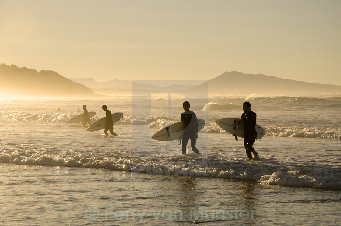 "Surfers leaving the waves behind" stock image