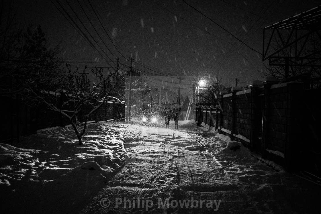 "Car headlights and two figures in a blizzard, Bishkek Kyrgyzstan." by Philip Mowbray - $12.31 "Car headlights and two figures in a blizzard, Bishkek Kyrgyzstan." stock image