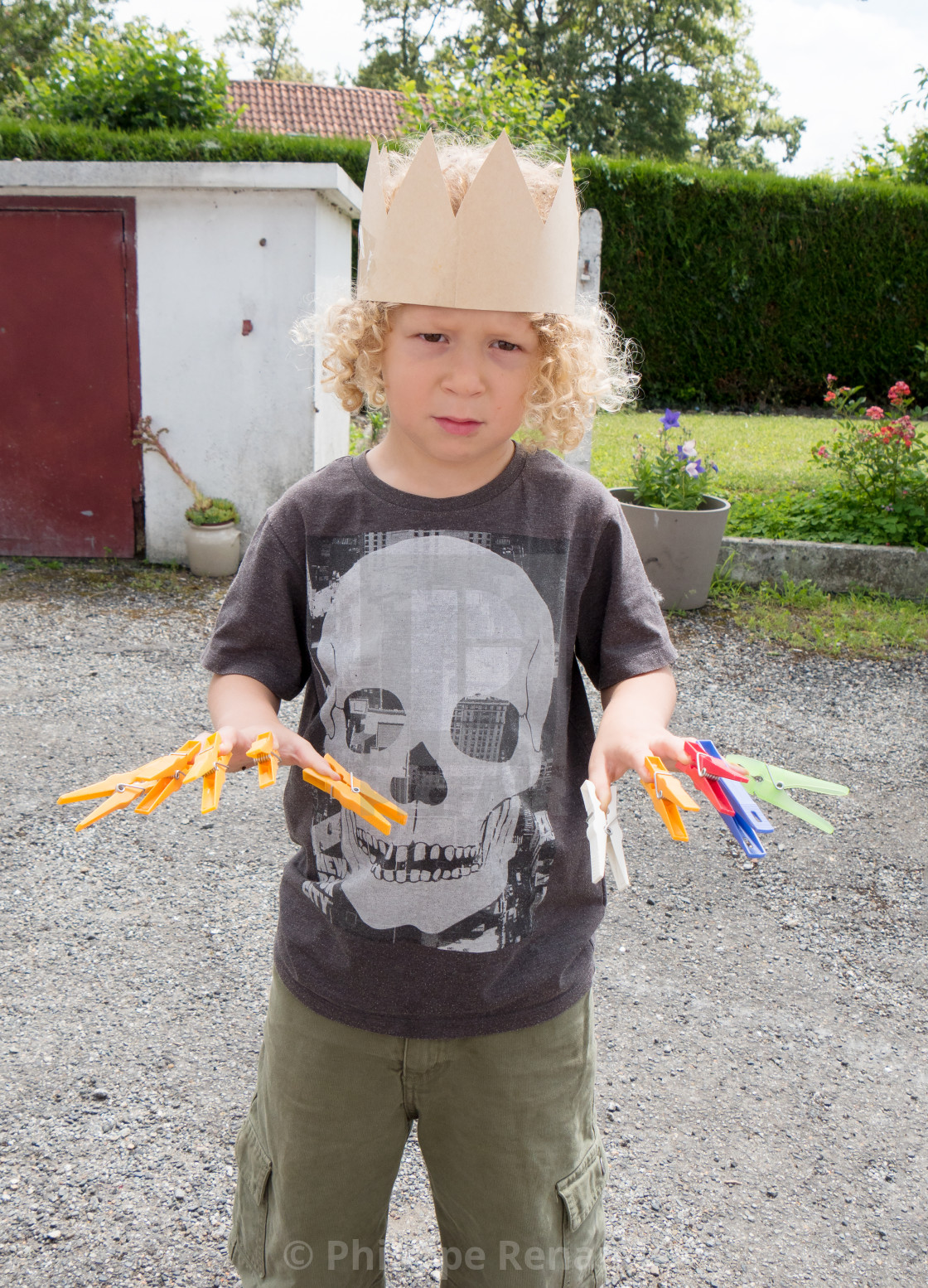 Little Boy With Blond Curly Hair Played With Laundry Pins