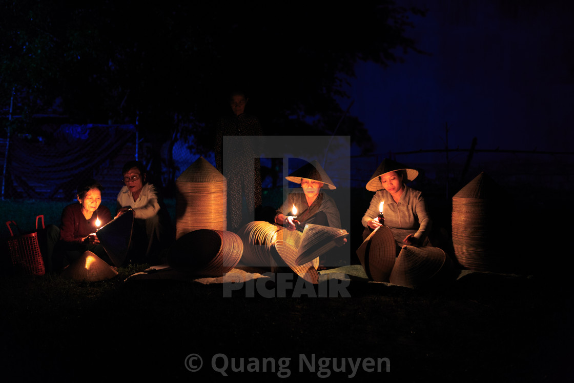 "Buy traditional conical hats which are made from the craftsmen in the early morning" stock image