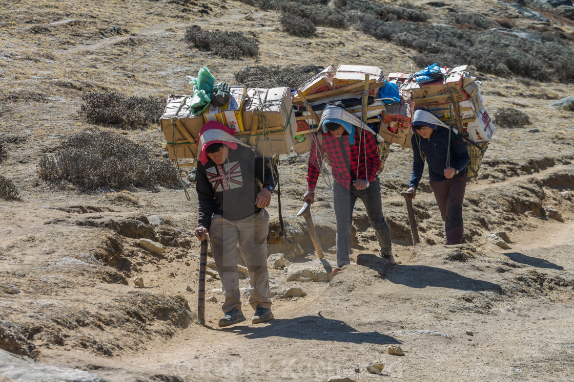 "Porters carrying a heavy loads en route towards the Everest Base Camp" stock image