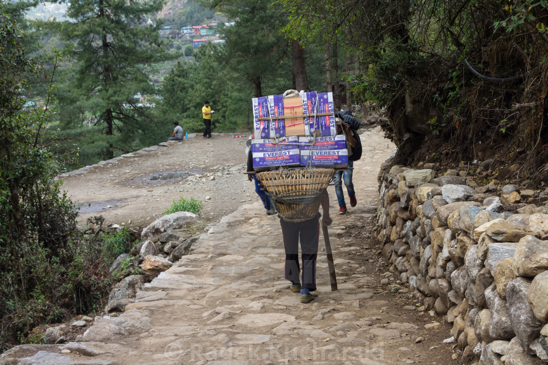 "Porter carrying a heavy load en route towards the Everest Base Camp" stock image