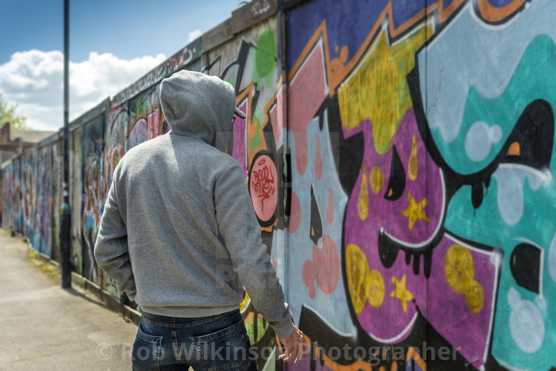 Back View Of A Male Wearing A Hoodie Standing By A Wall Of Graffiti Street Crime Concept License Download Or Print For 19 98 Photos Picfair