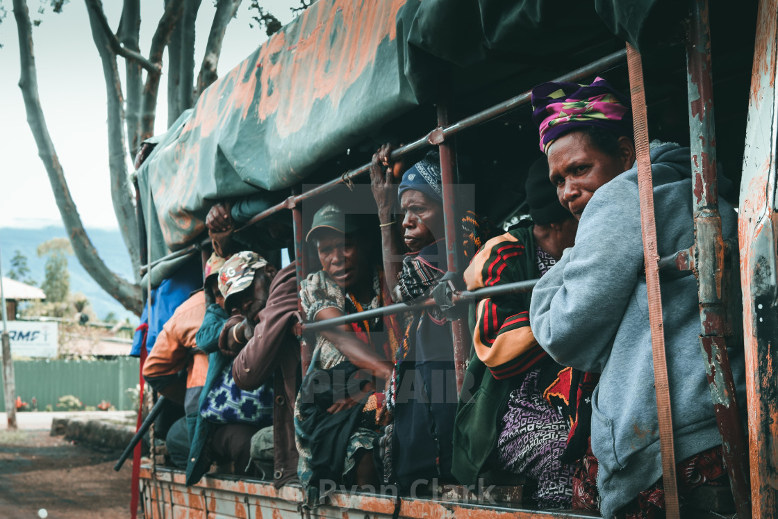 "Ladies looking out the back of a truck." stock image