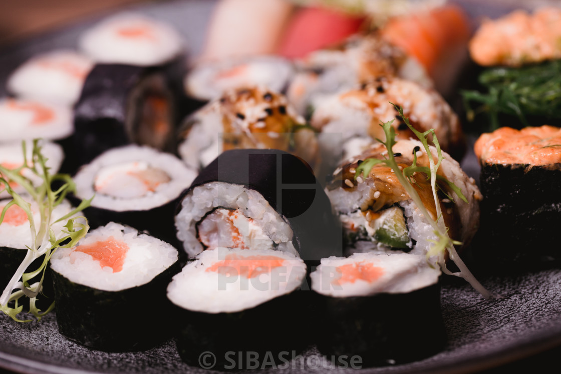 Closeup Sushi Nigiri And Rolls Served On Brown Wooden Table