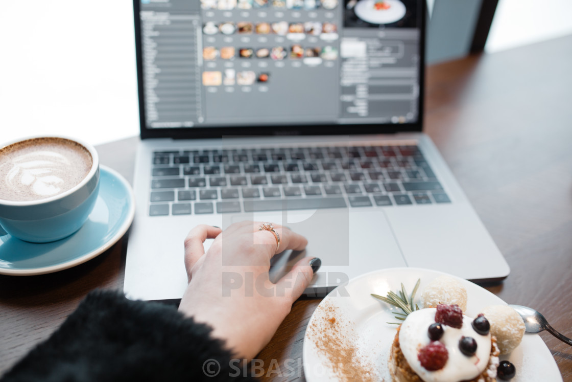 "Top view of designers place. Womens hand using tochpad on laptop. Freelance..." stock image