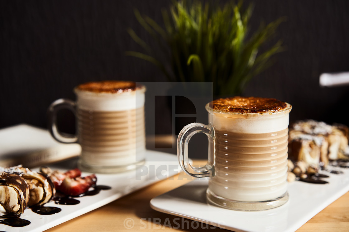 Two Cups Of Hot Latte With Baked Caramel Crust And Sweet Roll With Banana And License Download Or Print For 24 80 Photos Picfair