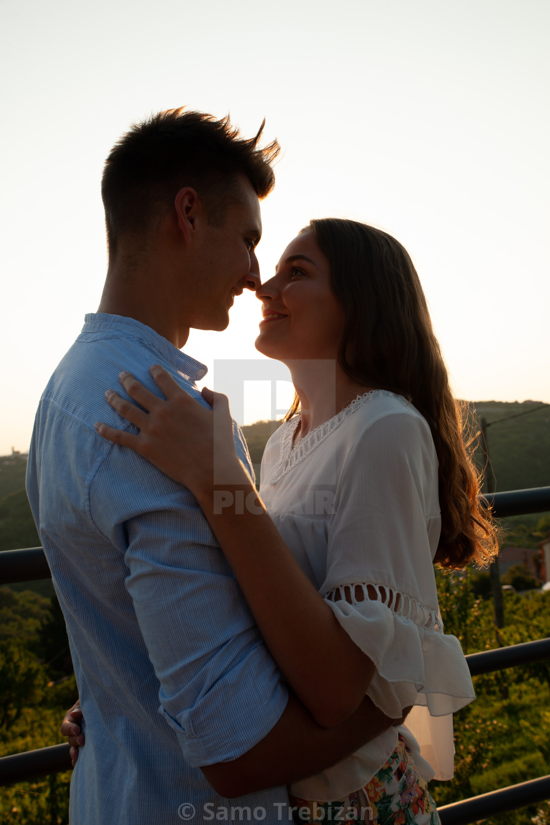 Silhouette of a beautiful romantic couple at sunset - License ...