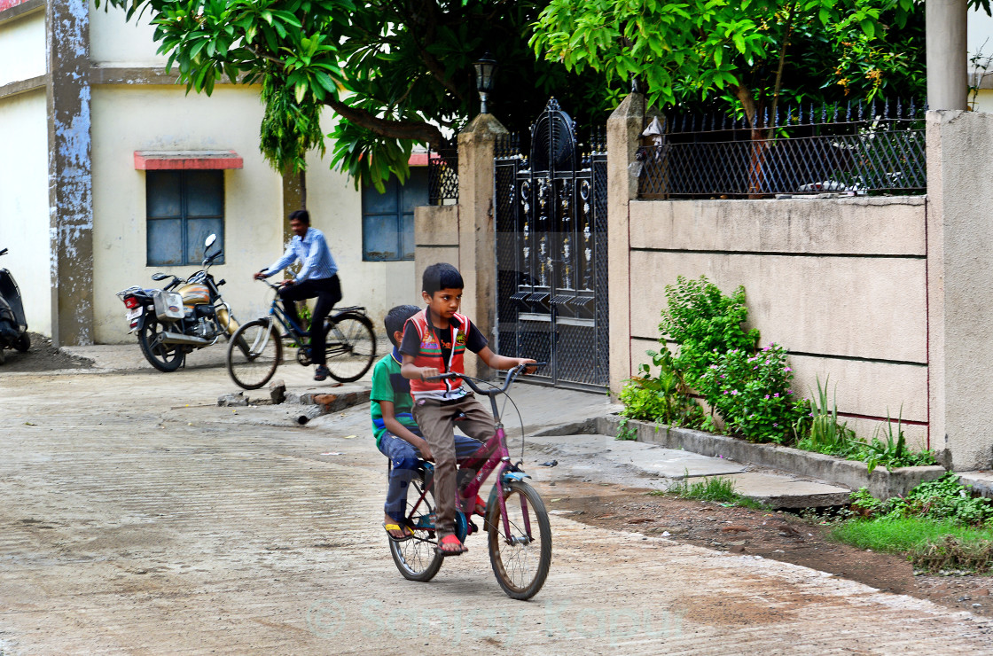 Indian Kids Enjoying Bicycle Ride License Download Or Print