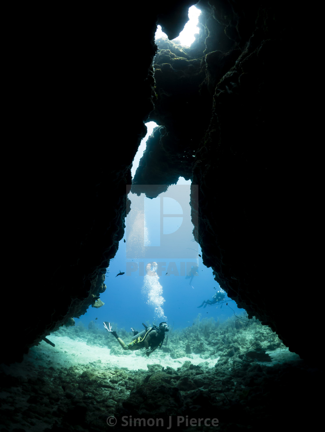 "Scuba divers outside a cave off Utila, Honduras" stock image