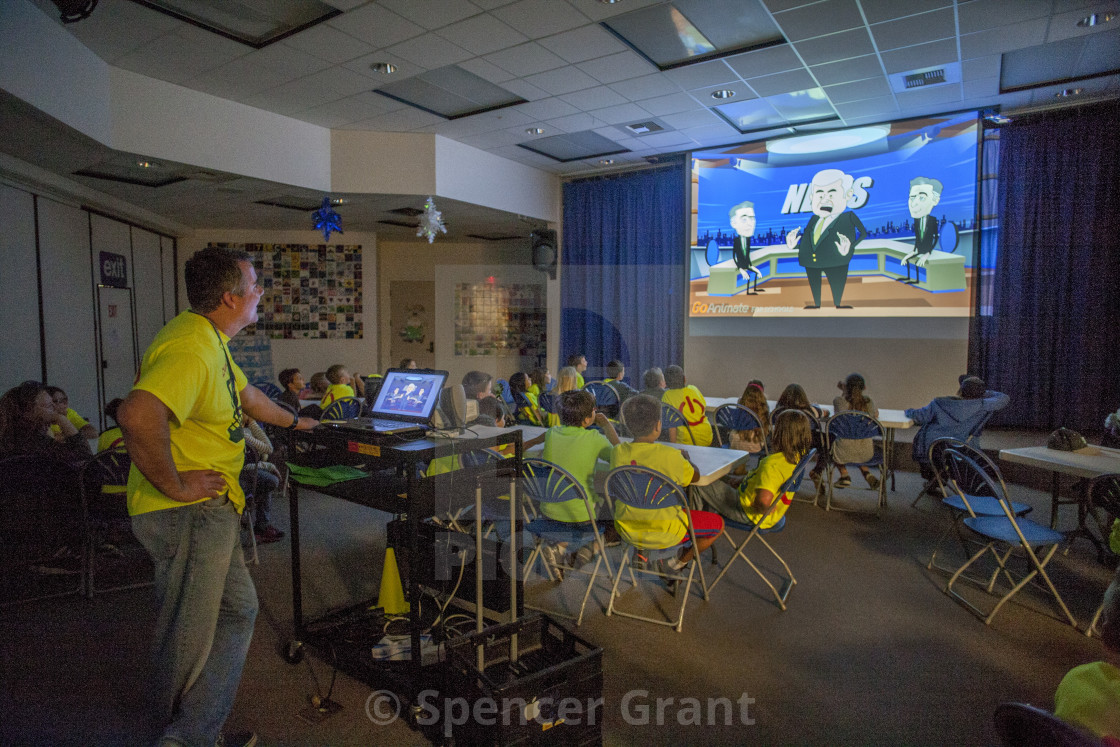 An Elementary School Teacher Shows His Students A Digital