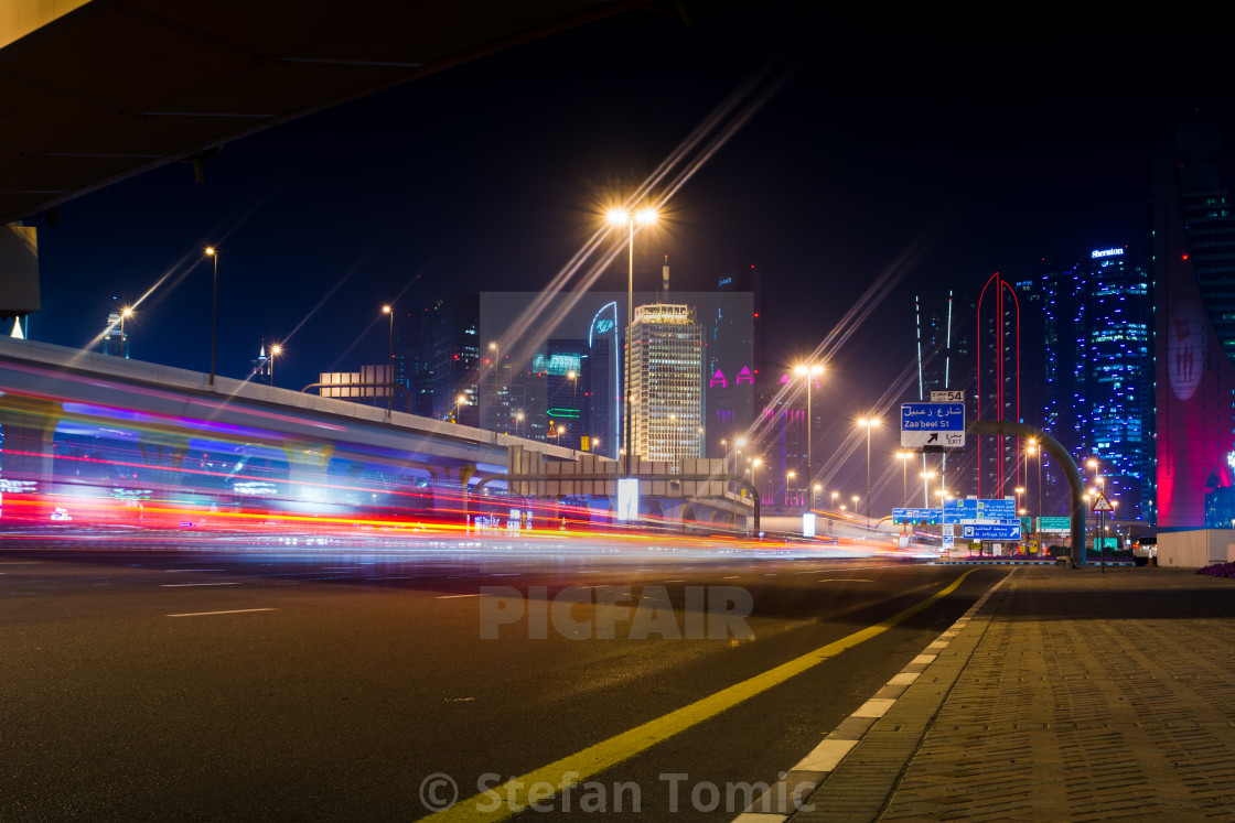 Dubai Street Scene With Traffic Light Trails And New City