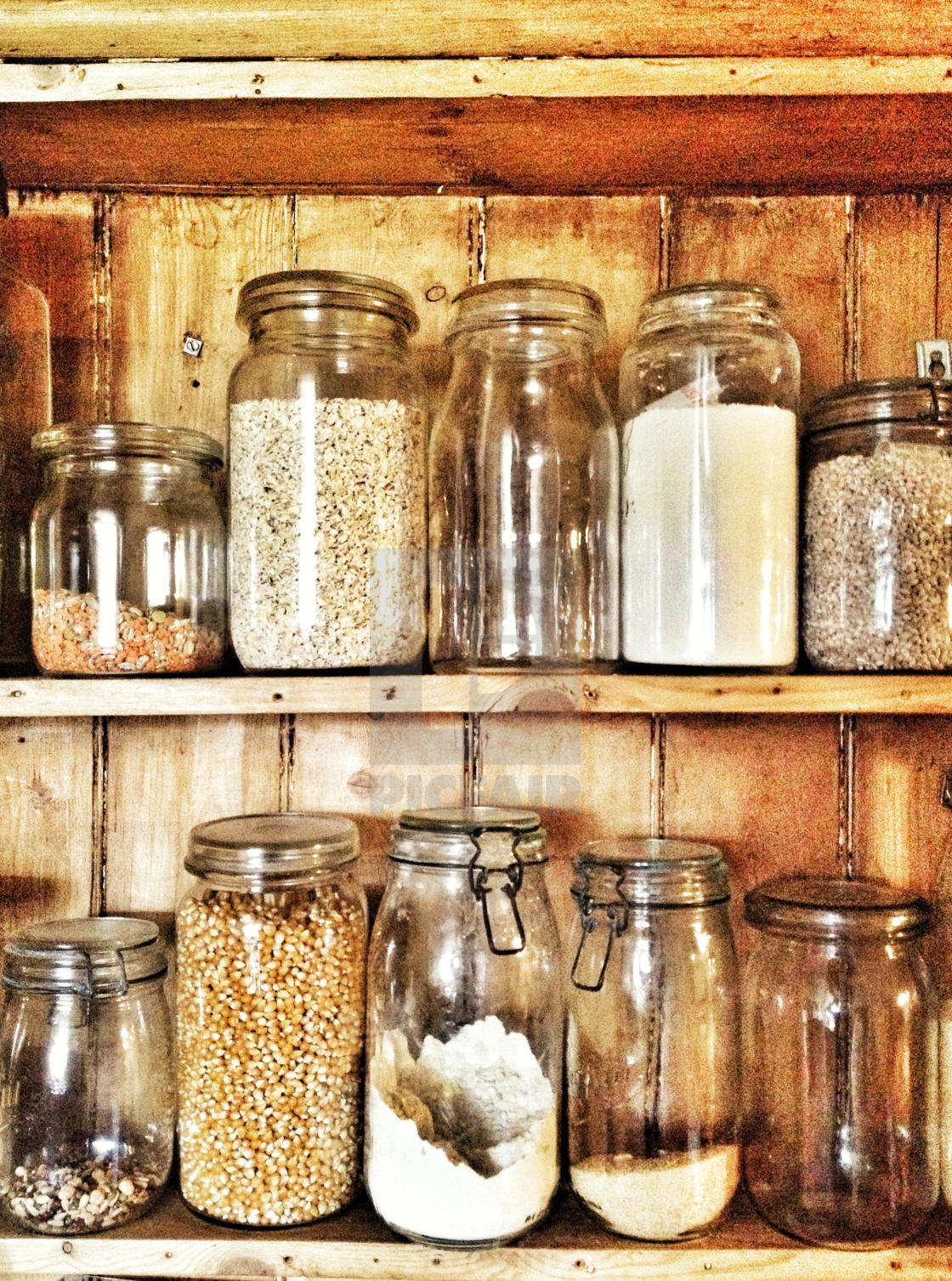 Old Fashioned Jars Containing Grains Pulses And Flour In Kitchen