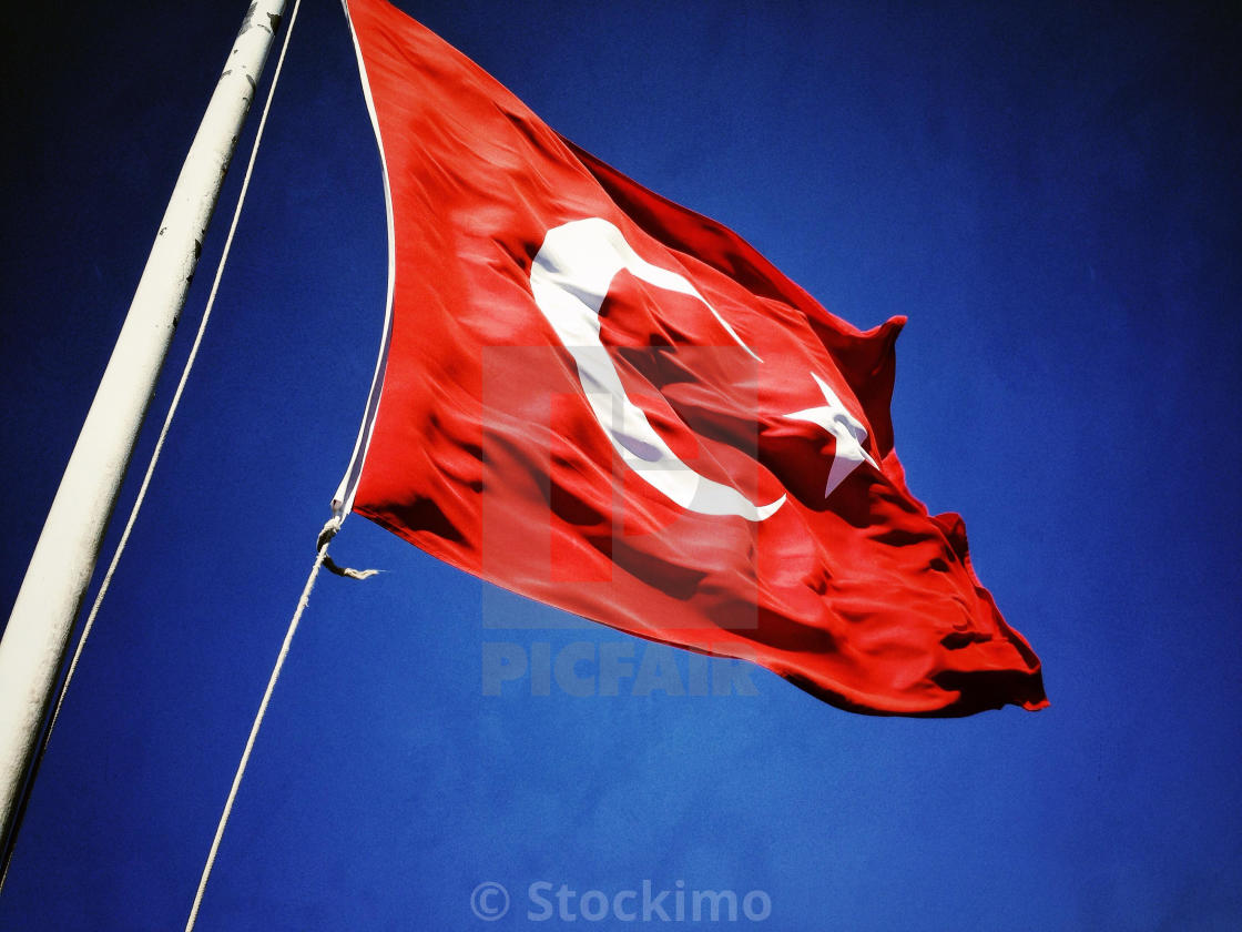 The Flag the Republic of Turkey. A red flag with a white 5 pointed star white Crescent Moon fluttering in a blue sky. Vexillology. Al Bayrak. Al Sancak. License,