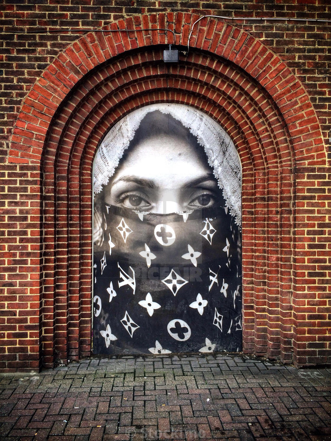 Street art installation by Moroccan born artist Hassan a woman wearing a Louis Vuitton niqab, in Old Street, Shoreditch, London, England. - License, download or print for £31.00 | | Picfair