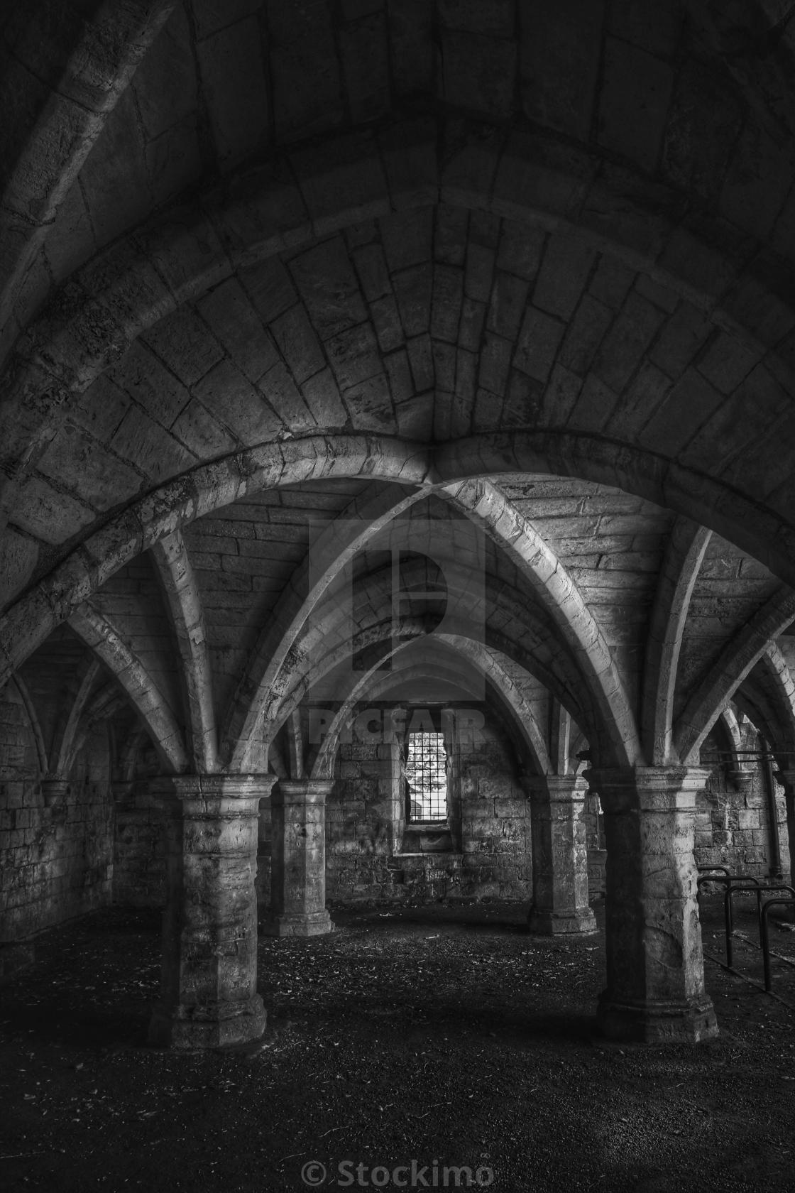 A Dark Dungeon With Ornate Stone Pillars Holding Up An Ornate