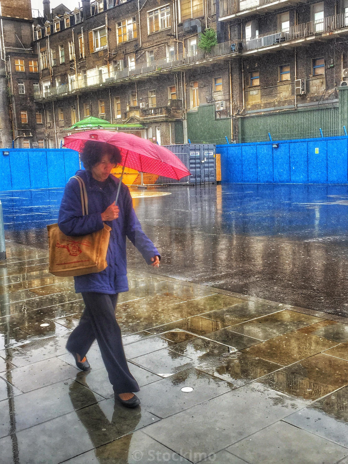 Walking In The Rain By An Old Apartment Block Whitechapel London