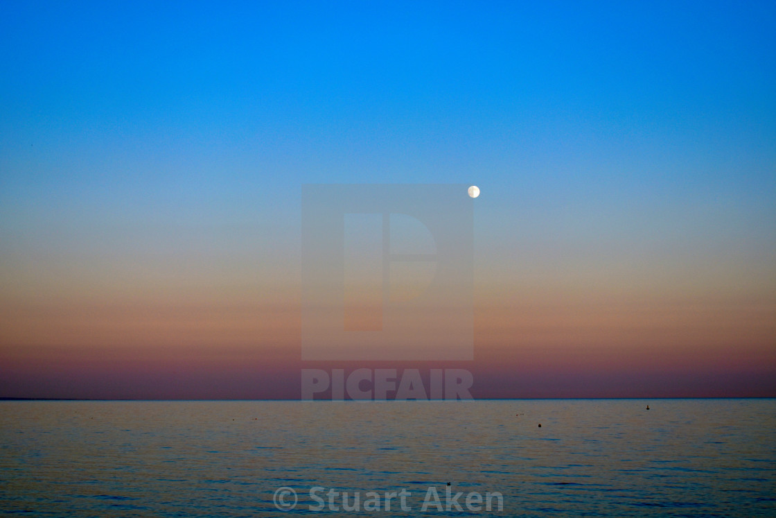 "Calm Sea, Full Moon at Dusk" stock image