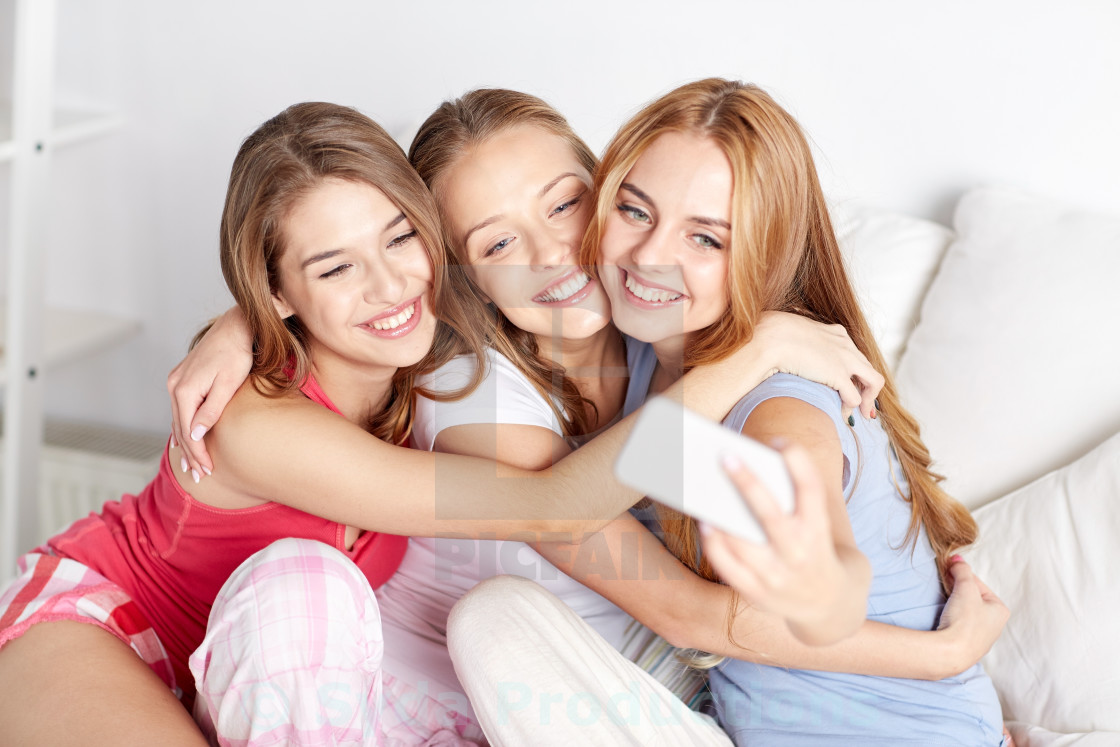 teen girls with smartphone taking selfie at home - License, download or ...