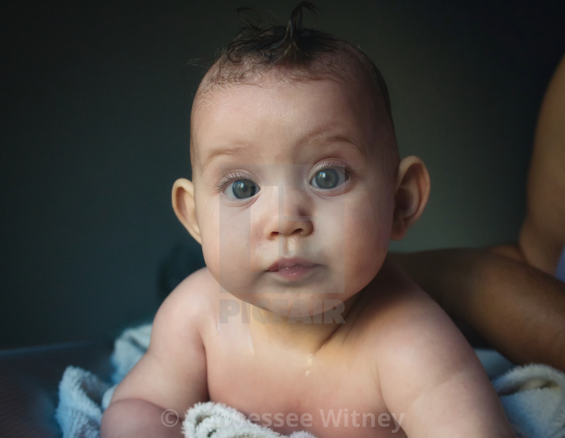 "Cute newborn baby just out of the bath with wet hair and face looking at the..." by Tennessee Witney - £4.91 "Cute newborn baby just out of the bath with wet hair and face looking at the..." stock image