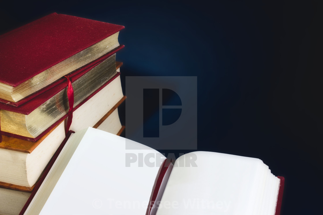 "Stack of old books and an open book with blank empty pages against a dark..." by Tennessee Witney - £4.91 "Stack of old books and an open book with blank empty pages against a dark..." stock image