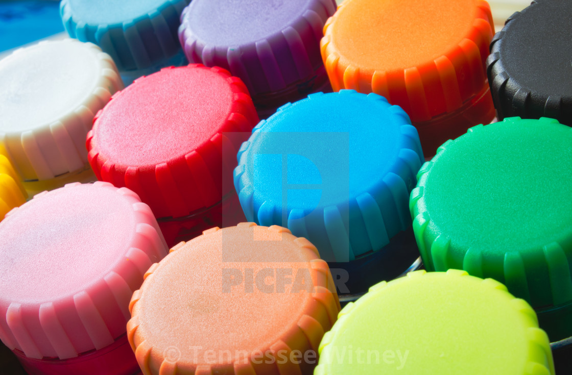 "Close-up of colourful lids of kids' poster paint pots" stock image