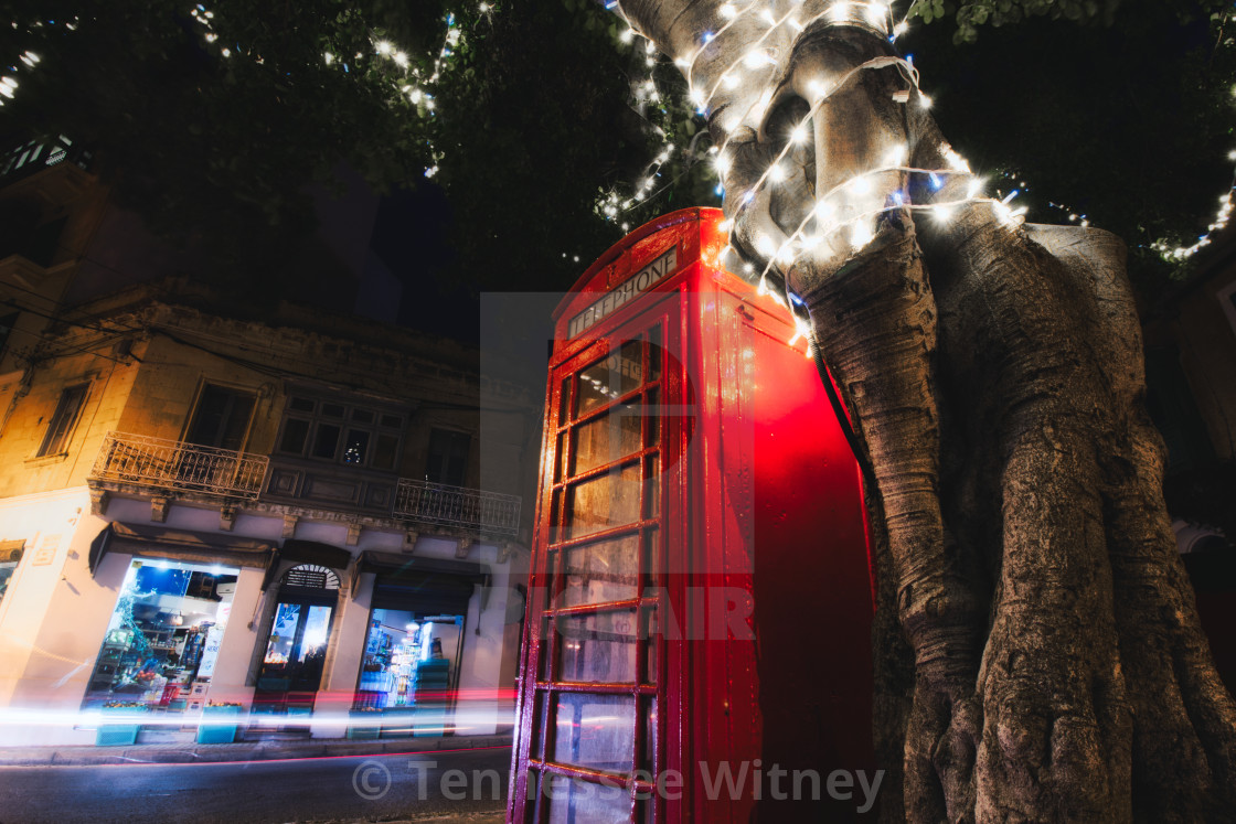 "Red telephone box at night with light trails from cars and a tree with white..." by Tennessee Witney - £7.25 "Red telephone box at night with light trails from cars and a tree with white..." stock image
