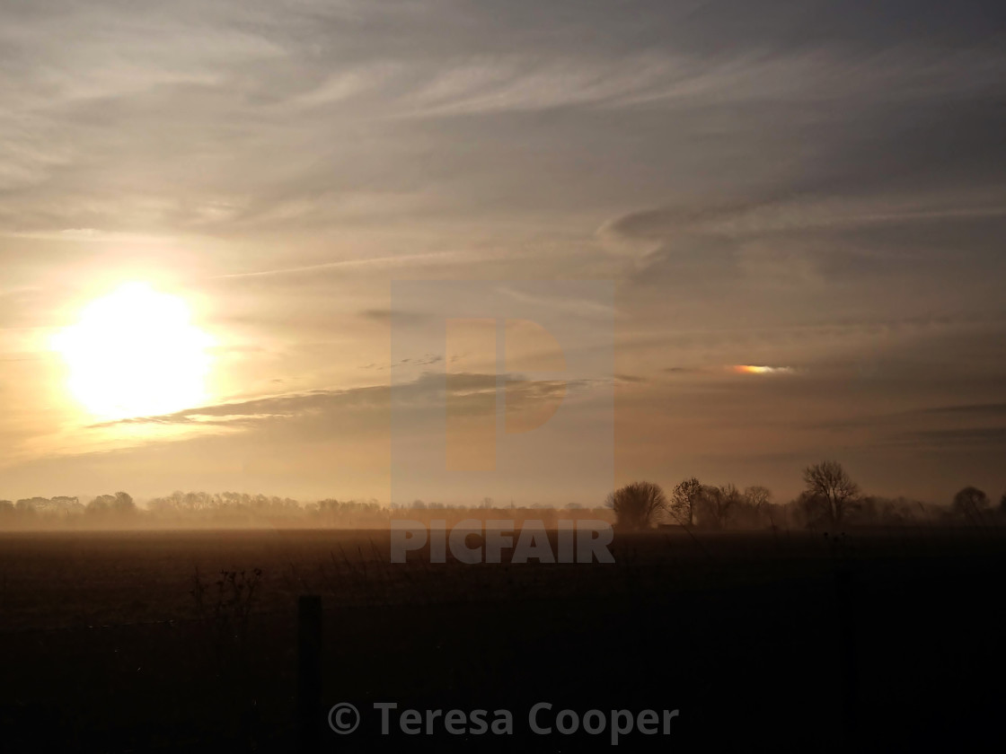 "A small rainbow cloud rises with the sun" stock image