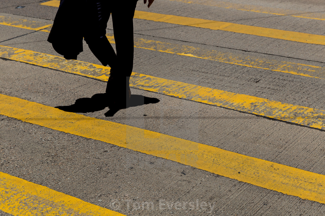 "Businessman wearing suit crossing road in Hong Kong" by Tom Eversley - $15.41 "Businessman wearing suit crossing road in Hong Kong" stock image