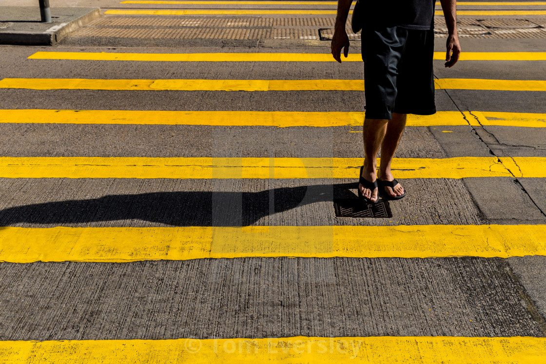 "Tourist man in shorts and sandals crossing road in Hong Kong" by Tom Eversley - $15.41 "Tourist man in shorts and sandals crossing road in Hong Kong" stock image