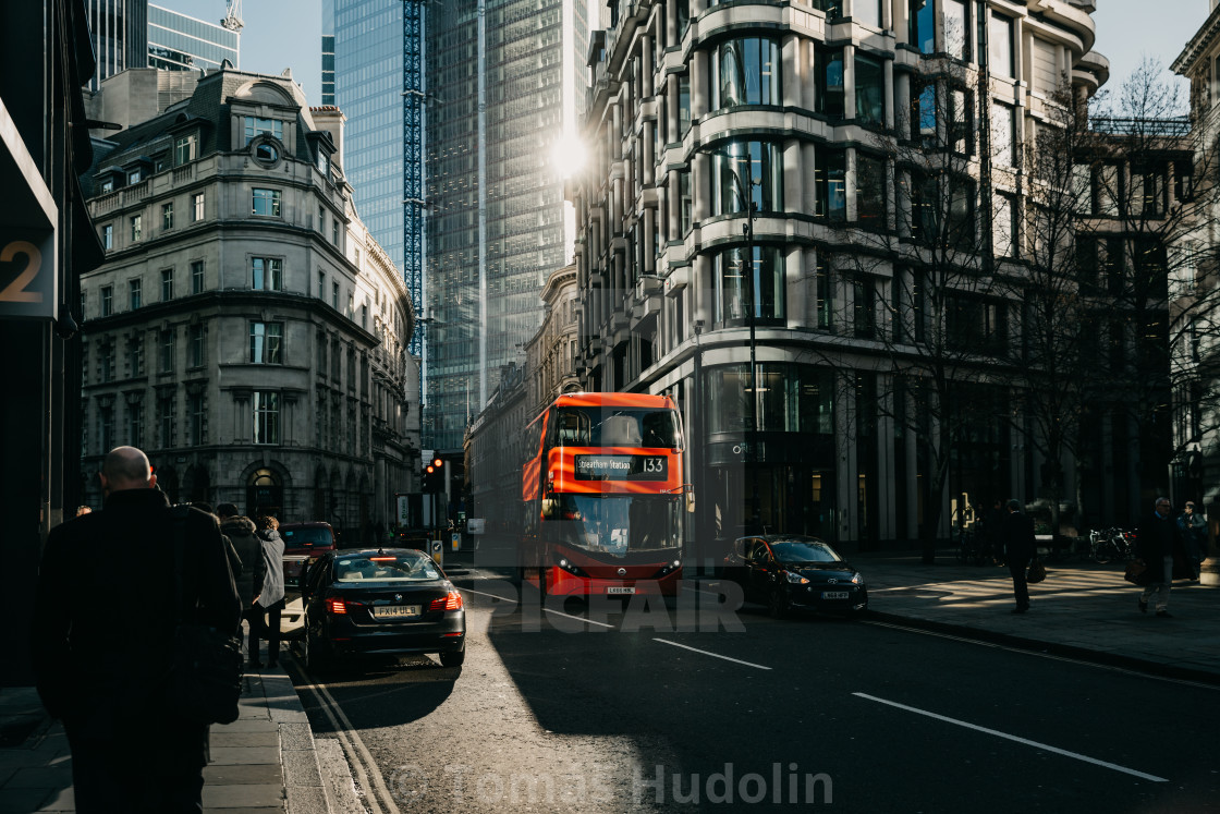 "The game of the sun light in the London street with the typical red bus of the London public transport" stock image