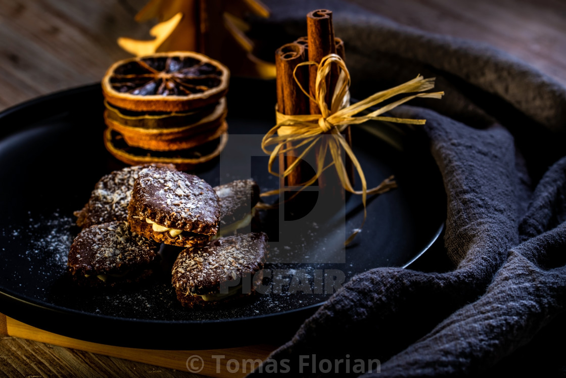 Brown Chocolate Sweets Stuffed By Cream On Black Plate With