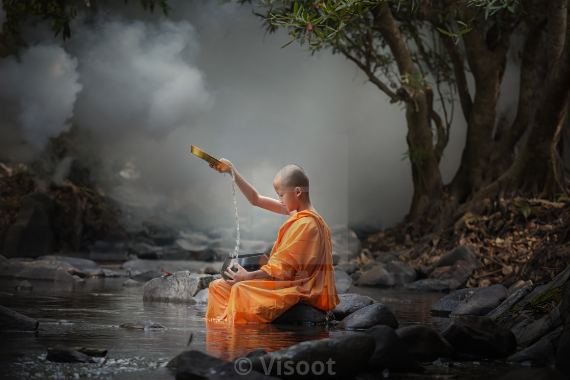 "Asia novice monk in the river." stock image